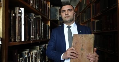 Kütahya Dumlupınar University President Süleyman Kızıltoprak shows a handwritten Quran bound in gazelle leather dating back to A.D. 1090, Kütahya, Türkiye, June 4, 2024. (IHA Photo)