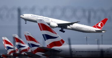 A Turkish Airlines Boeing 777 takes off past parked British Airways aircraft at Heathrow Airport, London, Britain, May 17, 2021. (Reuters Photo)
