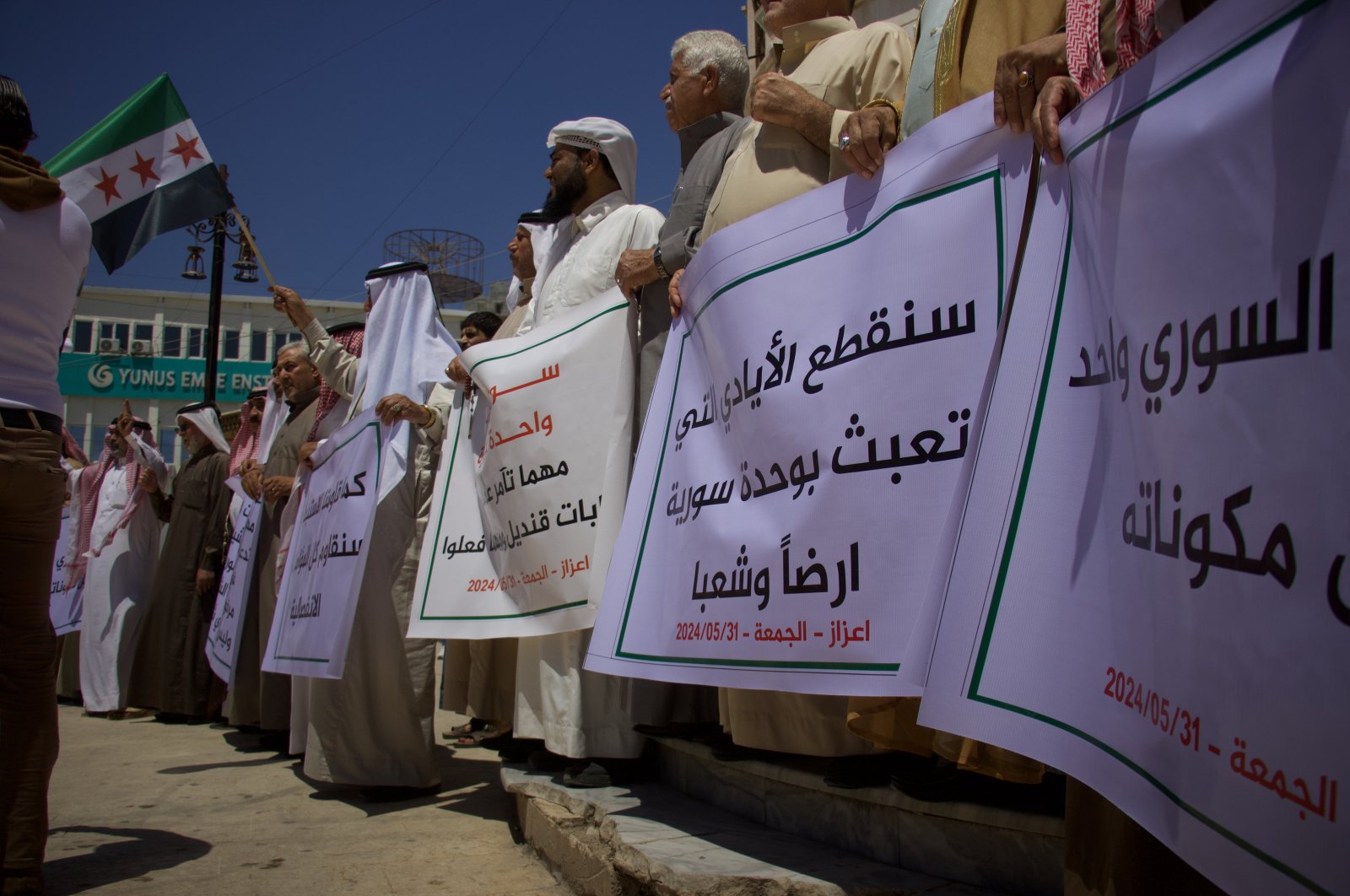 Protesters hold placards condemning PKK/YPG terrorists&#039; planned "elections" in northern Syria, May 31, 2024. (AA Photo)