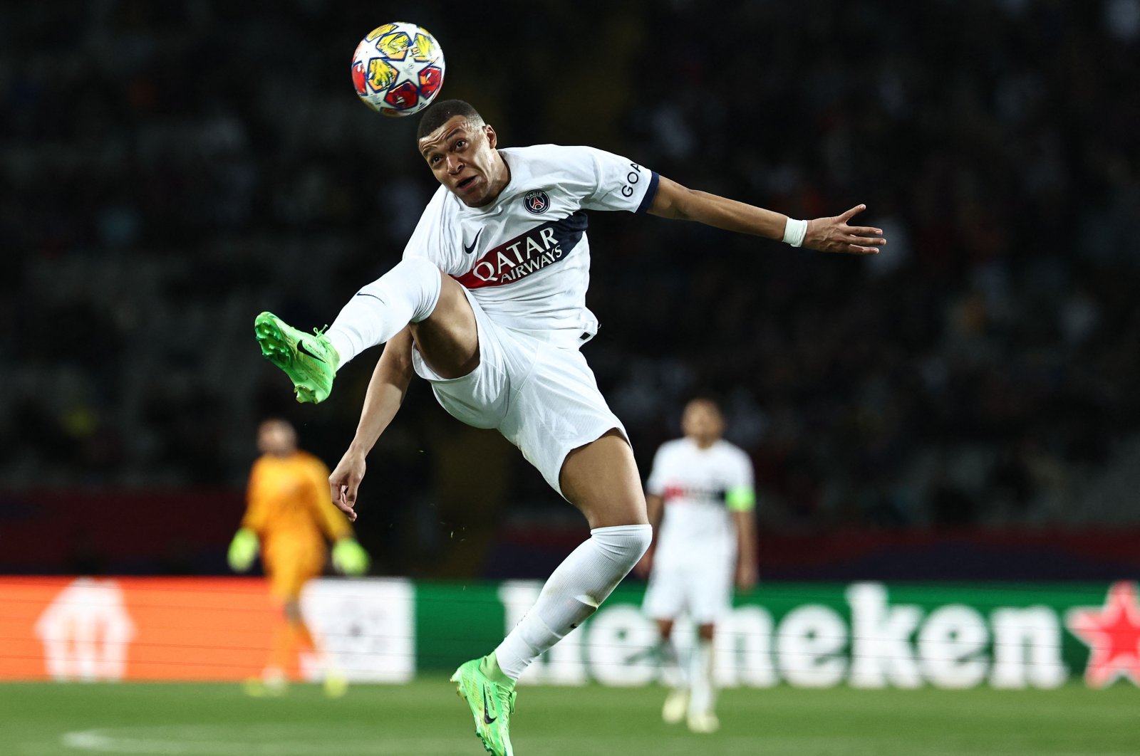 Kylian Mbappe heads the ball during the UEFA Champions League quarterfinal second leg football match against Barcelona at the Estadi Olimpic Lluis Companys, Barcelona, Spain, April 16, 2024. (AFP Photo)