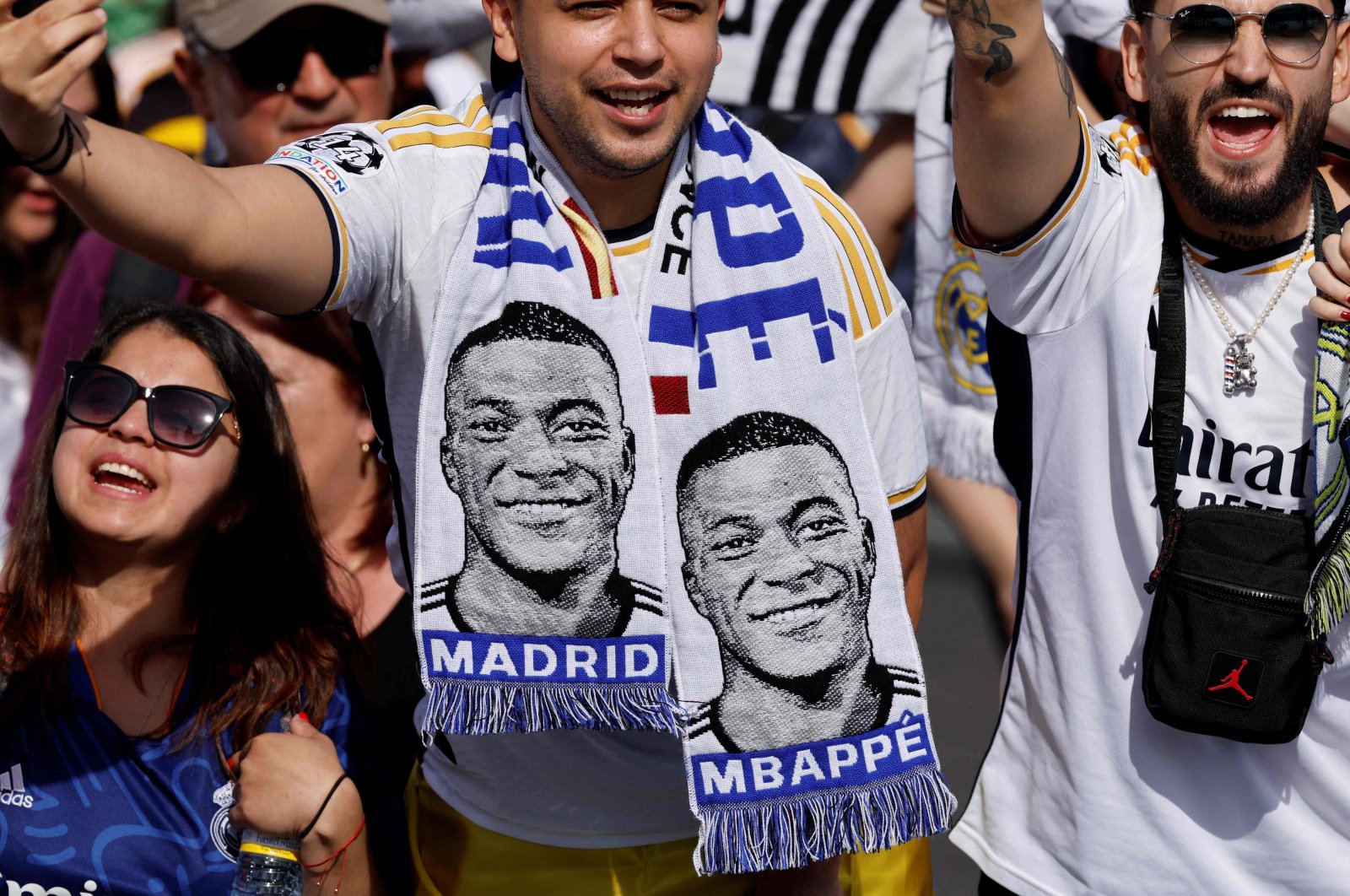 Supporters wearing football scarves depicting French footballer Kylian Mbappe cheer prior Real Madrid&#039;s celebration for winning 2024 Spanish La Liga title at Cibeles square, Madrid, Spain, May 12, 2024. (AFP Photo)