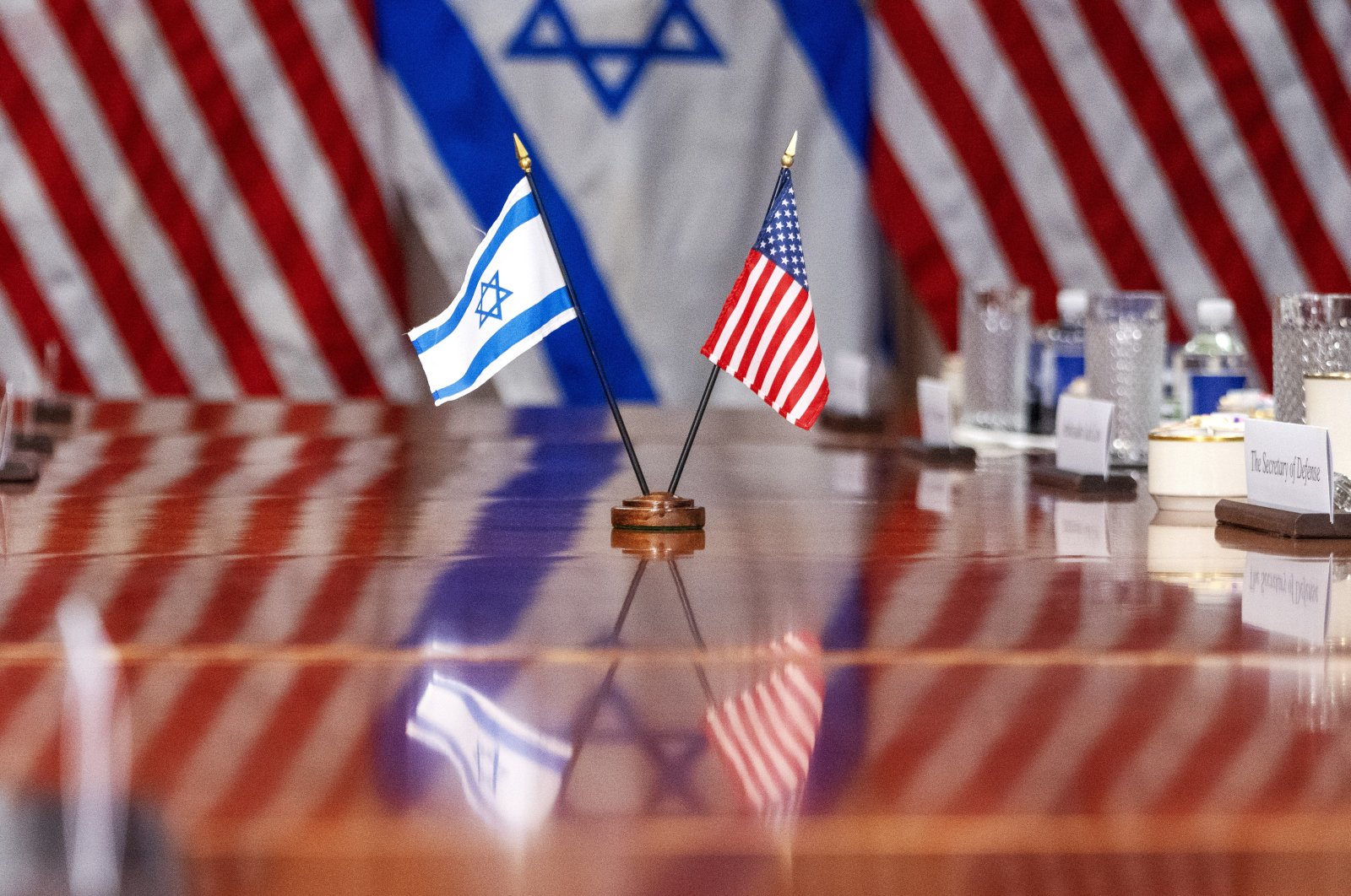 An Israeli and U.S. flag are reflected on a conference table as Defense Secretary Lloyd Austin meets with Israeli Defense Minister Yoav Gallant, at the Pentagon, in Washington, U.S., March 26, 2024. (AP Photo)