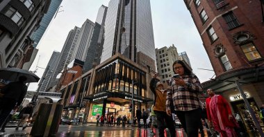 Shoppers make their way through the central business district on a rainy day in Sydney, Australia, May 10, 2024. (AFP Photo)