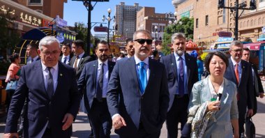 Foreign Minister Hakan Fidan (C) tours the International Grand Bazaar in Urumqi, the capital of Xinjiang province, China, June 5, 2024. (AA Photo)