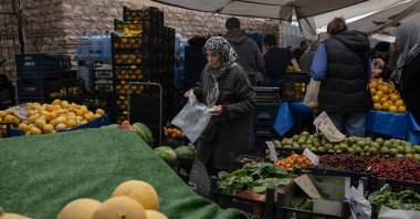 A customer selects fruit and vegetables at a Friday Bazaar market in Istanbul, Türkiye, May 10, 2024. (Getty Images Photo)