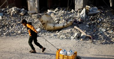 A Palestinian child pulls water containers in southern Gaza City, in the Gaza Strip, June 3, 2024. (Reuters Photo)