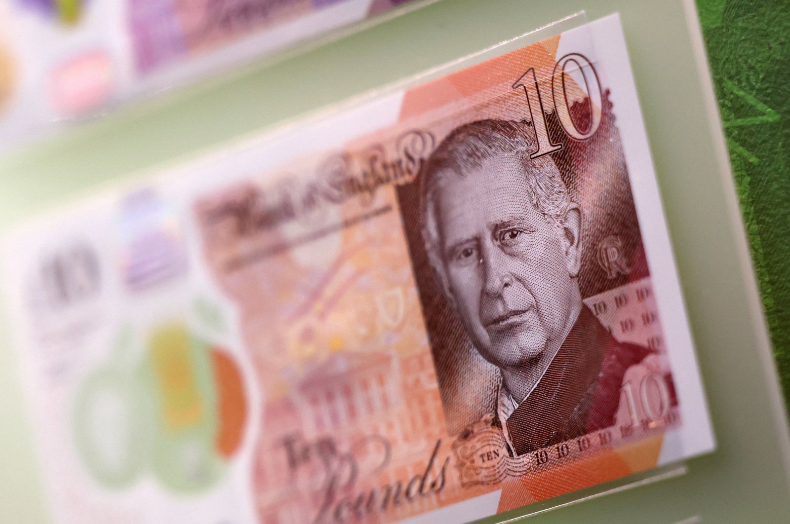 Bank notes and coins that feature an image of Britain&#039;s King Charles III are pictured on display during a photocall for &quot;The Future of Money&quot; exhibition, at the Bank of England Museum, City of London, U.K., Feb. 27, 2024. (AFP Photo)