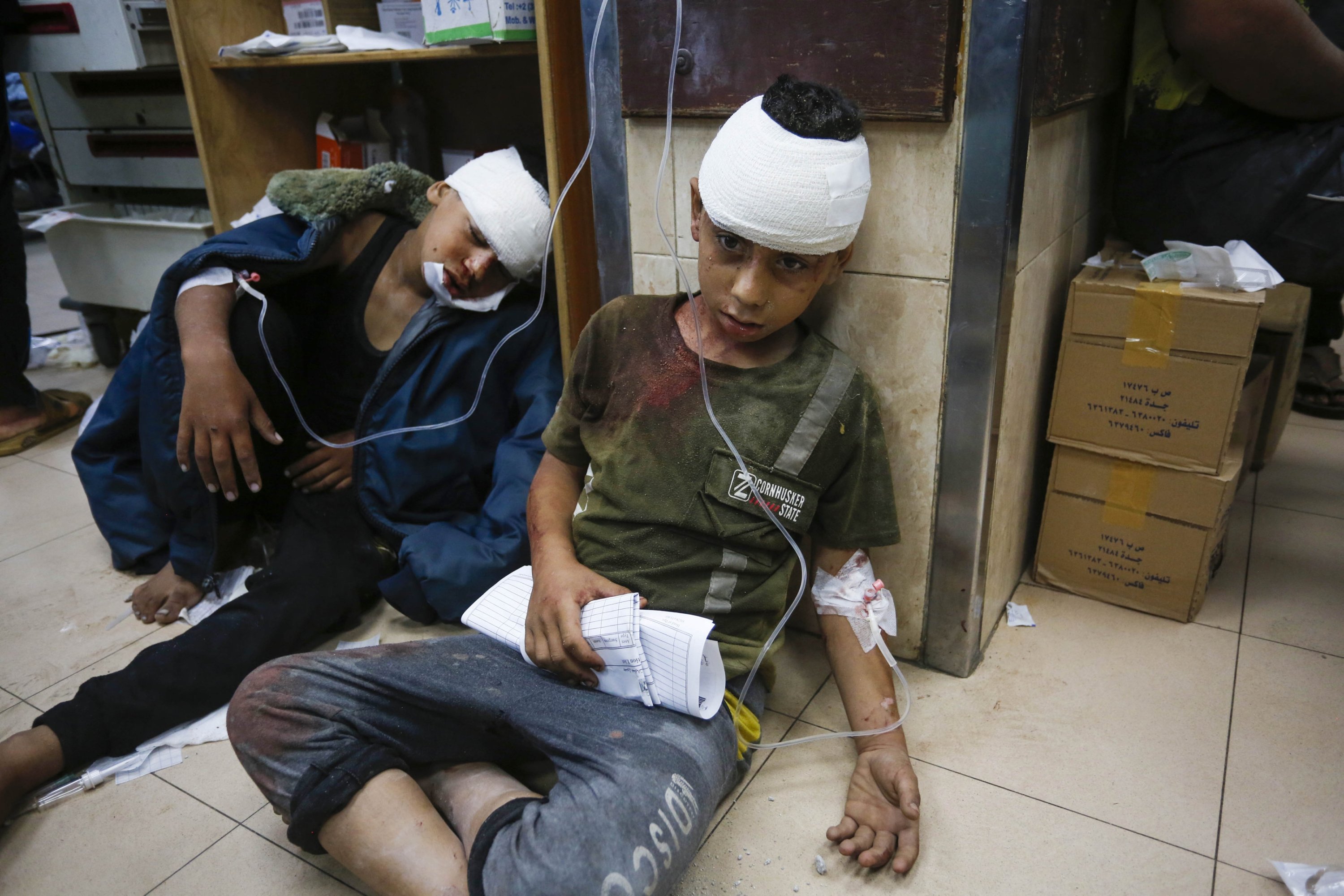 Two Palestinian children receive treatment for injuries sustained during an Israeli strike on a UNRWA school housing displaced people in Nuseirat refugee camp, central Gaza, Palestine, June 6, 2024. (AA Photo)