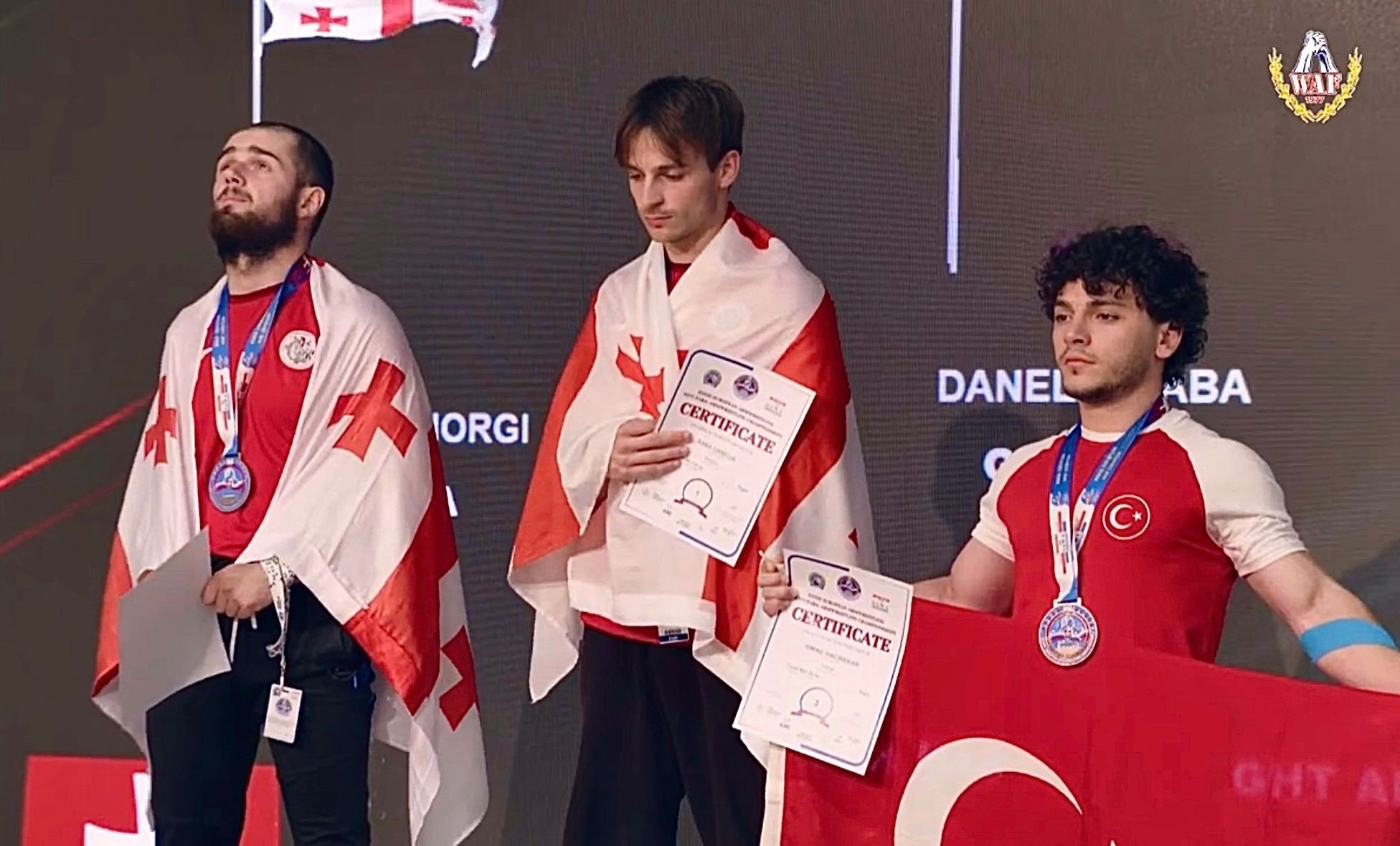 Turkish arm wrestler Ismail Hacı Bekar (R) on the podium after the European Arm Wrestling Championships, Bratislava, Slovakia, May 5, 2024. (IHA Photo)