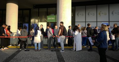 People wait for their turn at a visa application center in Istanbul, Türkiye, Nov. 3, 2023. (AP Photo)