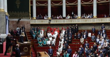  French members of Parliament stand during a session of questions to the government at the National Assembly, after French Member of Parliament of "La France Insoumise" (LFI) group Rachel Keke waved a Palestinian flag in the Assembly Chamber in Paris on June 4, 2024. (AFP Photo)