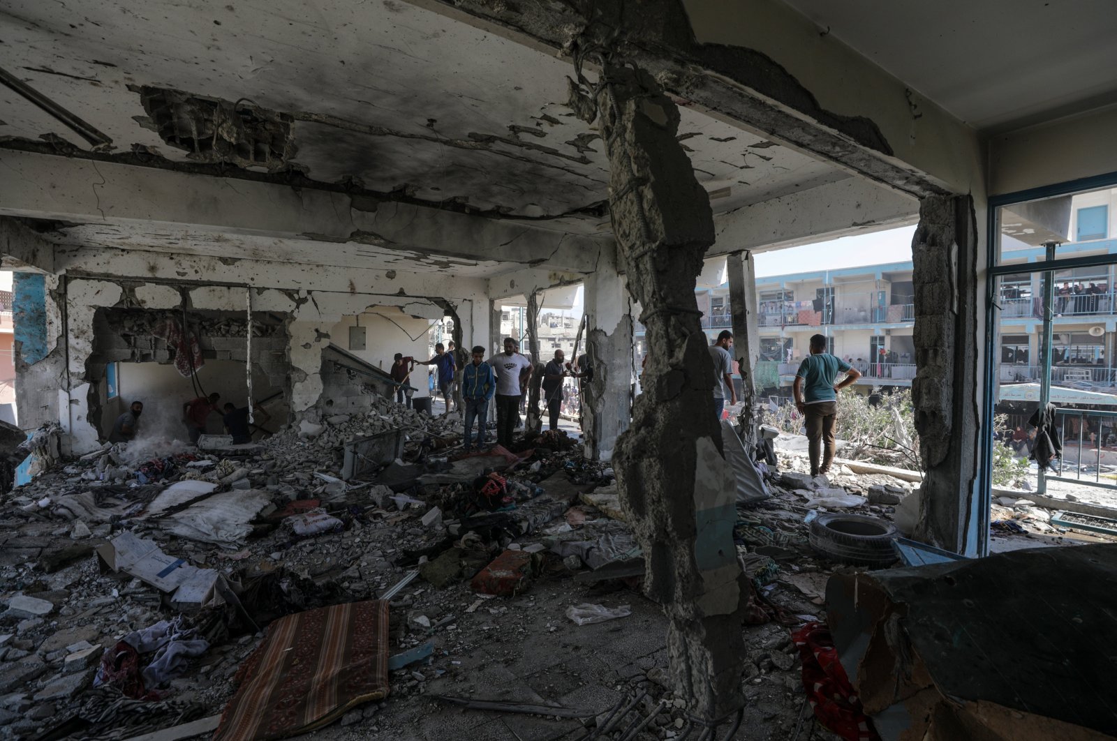 Palestinians inspect a destroyed UNRWA school following an Israeli air strike in Nuseirat refugee camp in the central Gaza Strip, June 6,  2024. (EPA Photo)