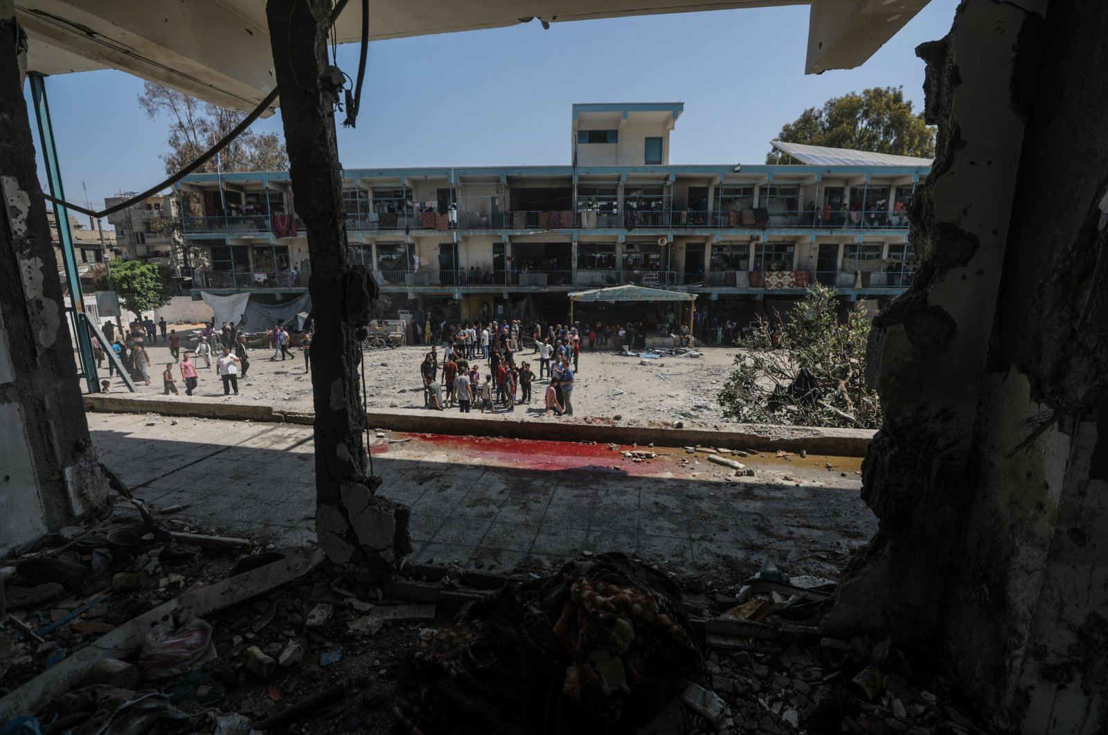 Palestinians inspect a destroyed UNRWA school following an Israeli air strike in Nuseirat refugee camp in the central Gaza Strip, June 6, 2024. (EPA Photo)