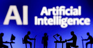Figurines with computers and smartphones are seen in front of the words &quot;Artificial Intelligence AI&quot; in this illustration taken Feb. 19, 2024. (Reuters Photo)