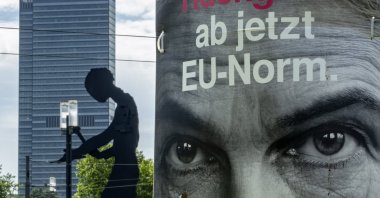 An election poster of Germany&#039;s Free Democratic Party&#039;s top candidate, Marie-Agnes Strack-Zimmermann fixed on a pole reads "spine: from now on EU norm" with "the hammering man", a statue by U.S. artist Jonathan Borofsky, is seen in the background, Frankfurt, Germany, June 5, 2024. (AP Photo)