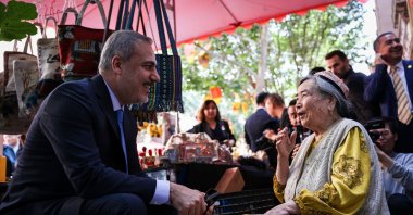 Foreign Minister Hakan Fidan talks to a woman during his tour in Kasghar, southern Xinjiang, China, June 5, 2024. (AA Photo)