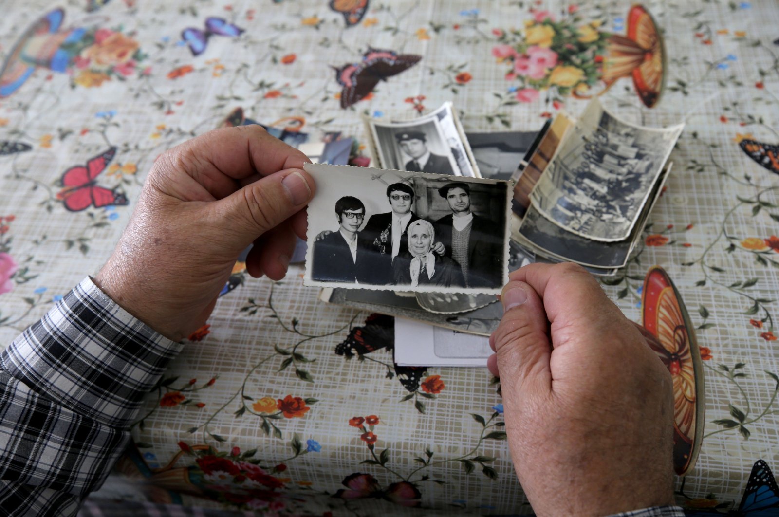 Turkish Bulgarian Seyfi Hacıali holds a family picture from his youth in Bulgaria before the forced expulsion of Turks in the 1980s, at an interview in his home, northwestern Kırklareli province, Türkiye, May 22, 2024. (AA Photo)