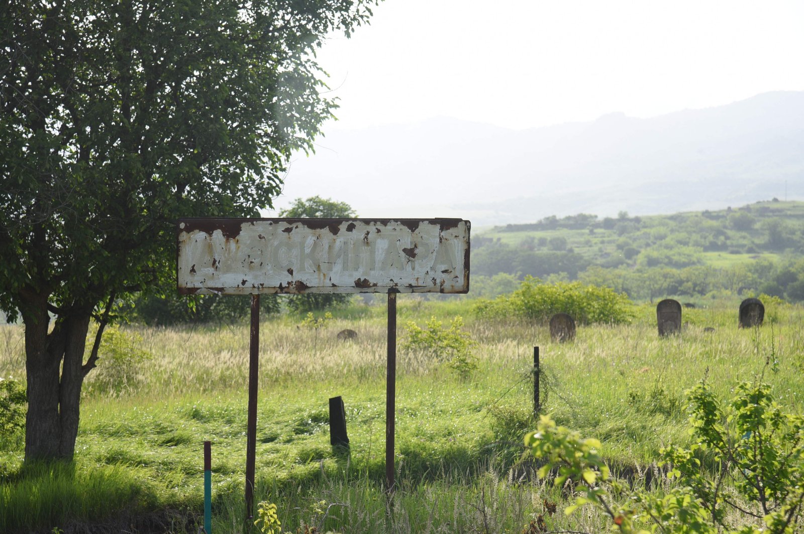 A rusty sign sits in the village of Ashaghi Askipara, one of the four villages Armenia recently returned to Azerbaijani control under a border demarcation deal between the Caucasus rivals, May 28, 2024. (AFP Photo)