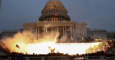 An explosion caused by a police munition is seen while supporters of then-President Donald Trump riot in front of the U.S. Capitol Building in Washington, U.S., Jan. 6, 2021. (Reuters File Photo)