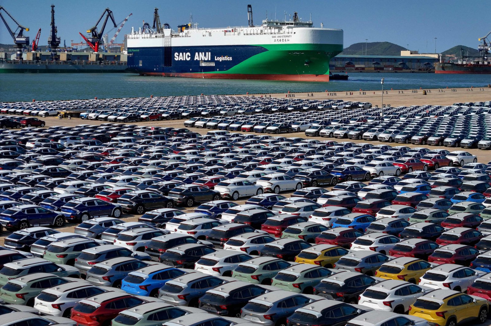 This aerial photograph taken shows cars for export waiting to be loaded on the &quot;SAIC Anji Eternity,&quot; a domestically manufactured vessel intended to export Chinese automobiles, at Yantai port, in eastern Shandong province, China, May 15, 2024. (AFP Photo)