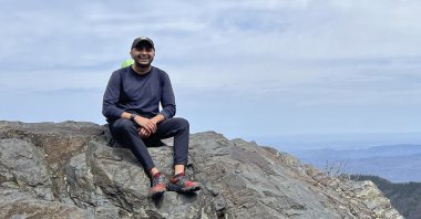 Prince Bhojwani sits on Charlies Bunion mountain along the Appalachian Trail in Great Smoky Mountains National Park in Tennessee on April 17, 2022. (AP Photo)