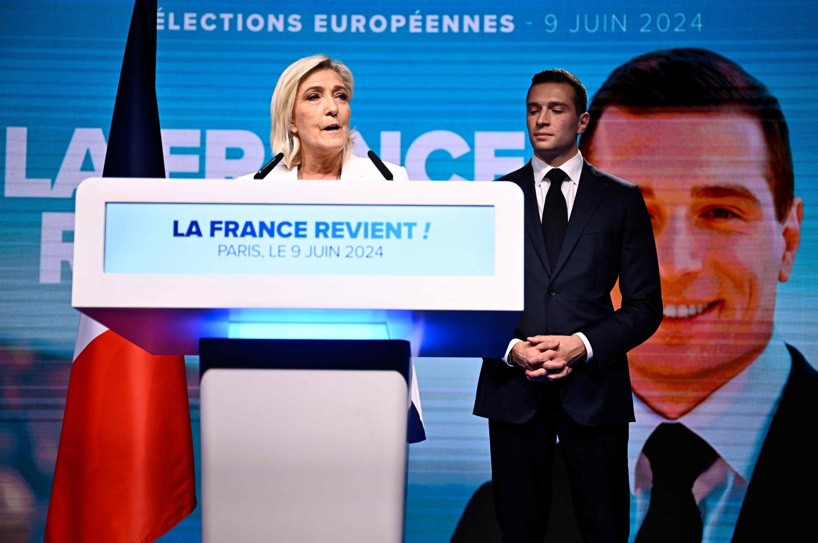 French far-right Rassemblement National (RN) party leader Marine Le Pen (L) addresses members as party President Jordan Bardella listens, in Paris, France, June 9, 2024. (AFP Photo)