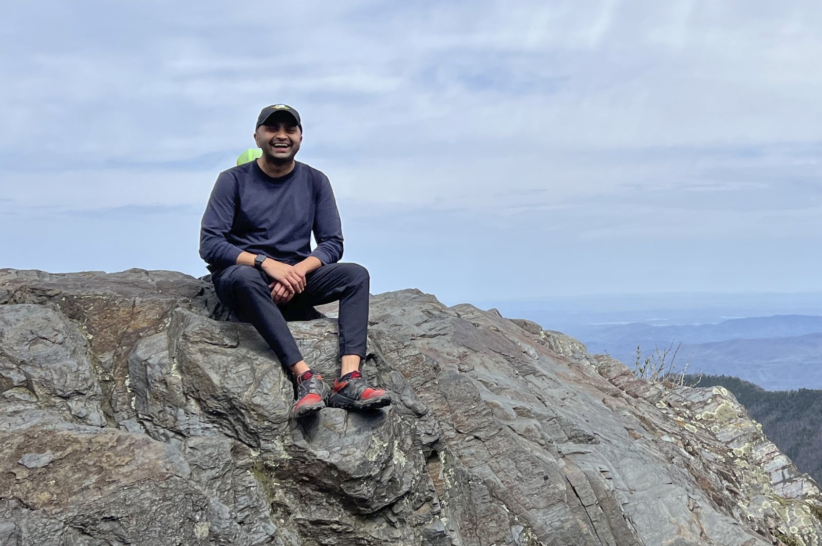 Prince Bhojwani sits on Charlies Bunion mountain along the Appalachian Trail in Great Smoky Mountains National Park in Tennessee on April 17, 2022. (AP Photo)