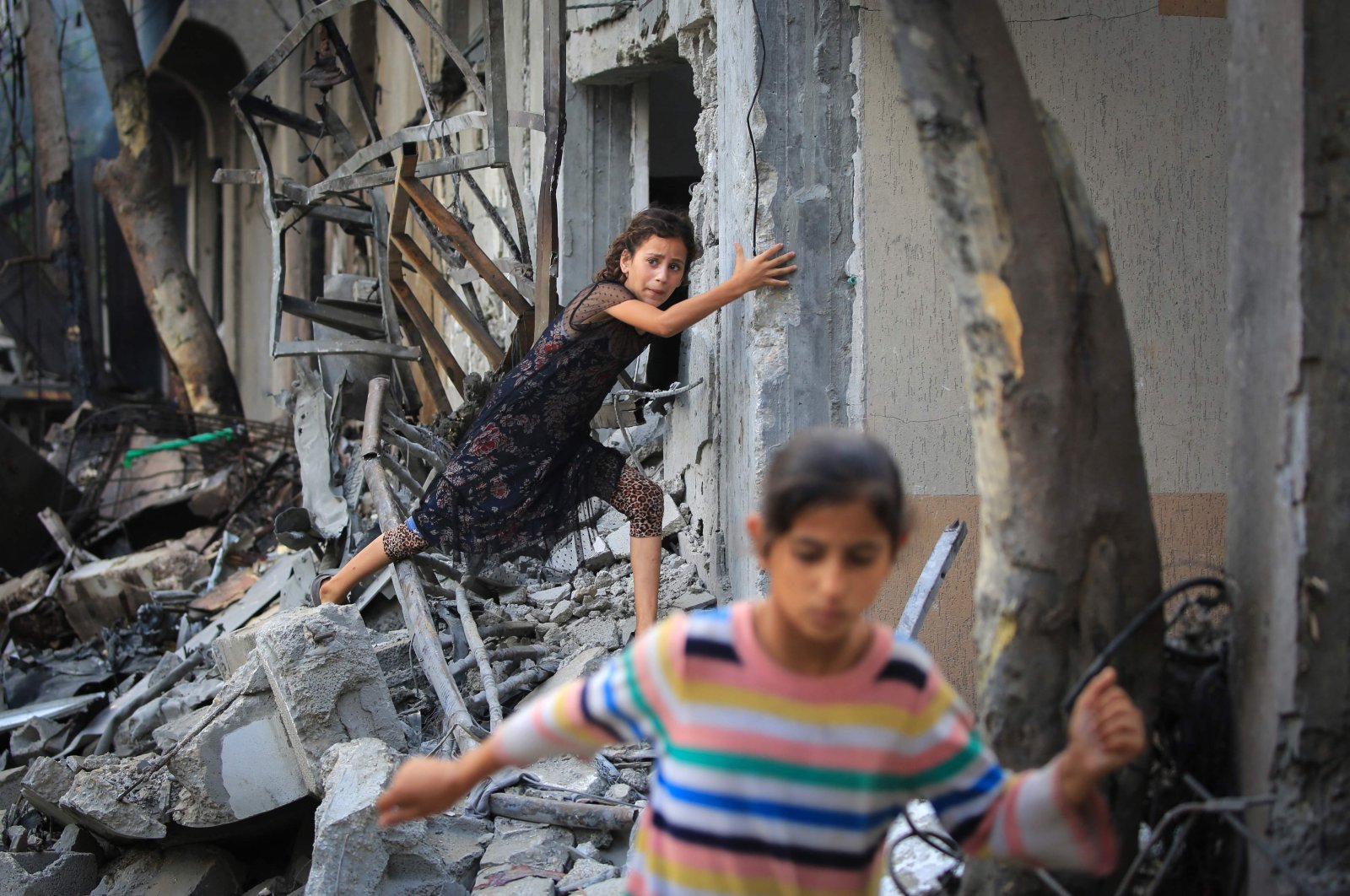 A Palestinian girl climbs over debris a day after an operation by the Israeli Special Forces in the Nuseirat camp, in the central Gaza Strip, Palestine, June 9, 2024. (AFP Photo)