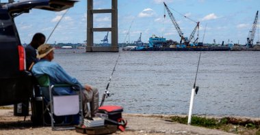 Men fish at Fort Armistead Park while clean-up operations continue around the Francis Scott Key Bridge as the main shipping channel prepares to fully reopen in Baltimore, Maryland, U.S., June 10, 2024. (Reuters Photo)