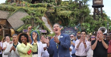 With Princess Tiana, Walt Disney World President Jeff Vahle cheers employees during a &quot;Thank You Fête&quot; honoring cast members at a preview event for Tiana&#039;s Bayou Adventure at the Magic Kingdom in Bay Lake, Florida, U.S., June 10, 2024. (AP Photo)