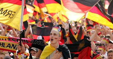 A German fan sings the German national anthem prior to the beginning of the Round of 16 of the World Cup match against Sweden at the public viewing area, Berlin, Germany, June 24, 2006. (AP Photo)