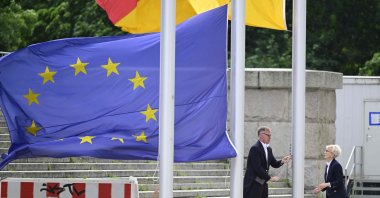Bundestag employees hoist the European and the German flags, in front of the Reichstag building housing the Bundestag (lower house of parliament) in Berlin, Germany, June 11, 2024. (AFP Photo)