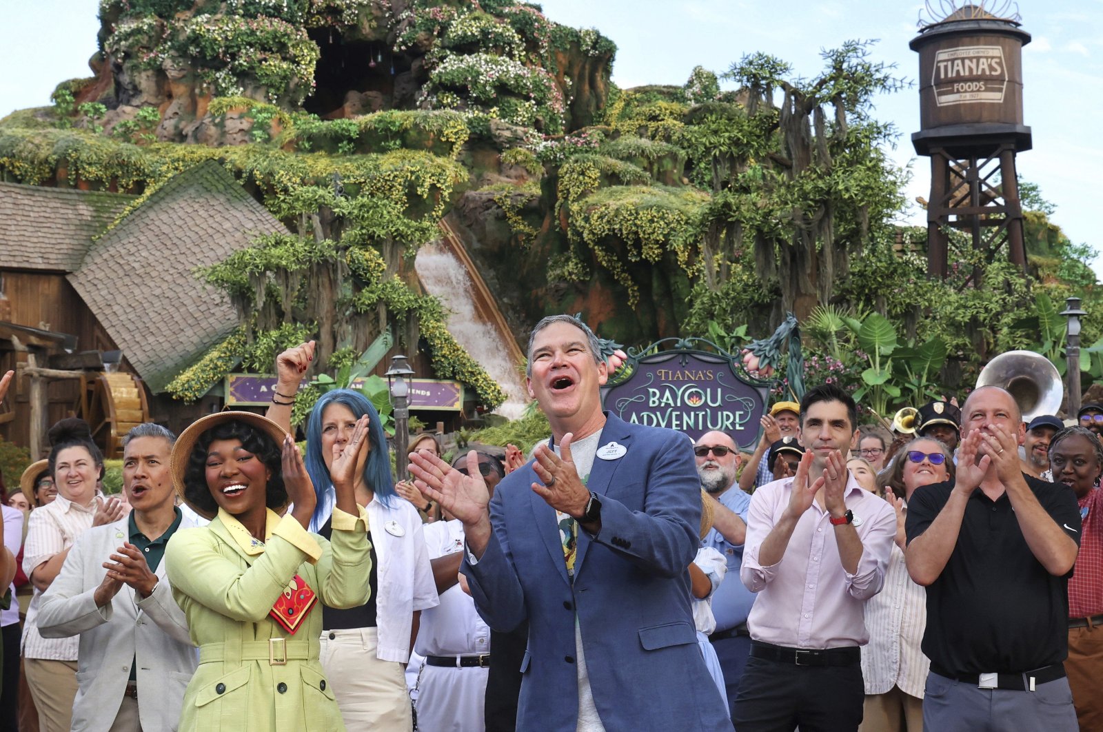 With Princess Tiana, Walt Disney World President Jeff Vahle cheers employees during a &quot;Thank You Fête&quot; honoring cast members at a preview event for Tiana&#039;s Bayou Adventure at the Magic Kingdom in Bay Lake, Florida, U.S., June 10, 2024. (AP Photo)