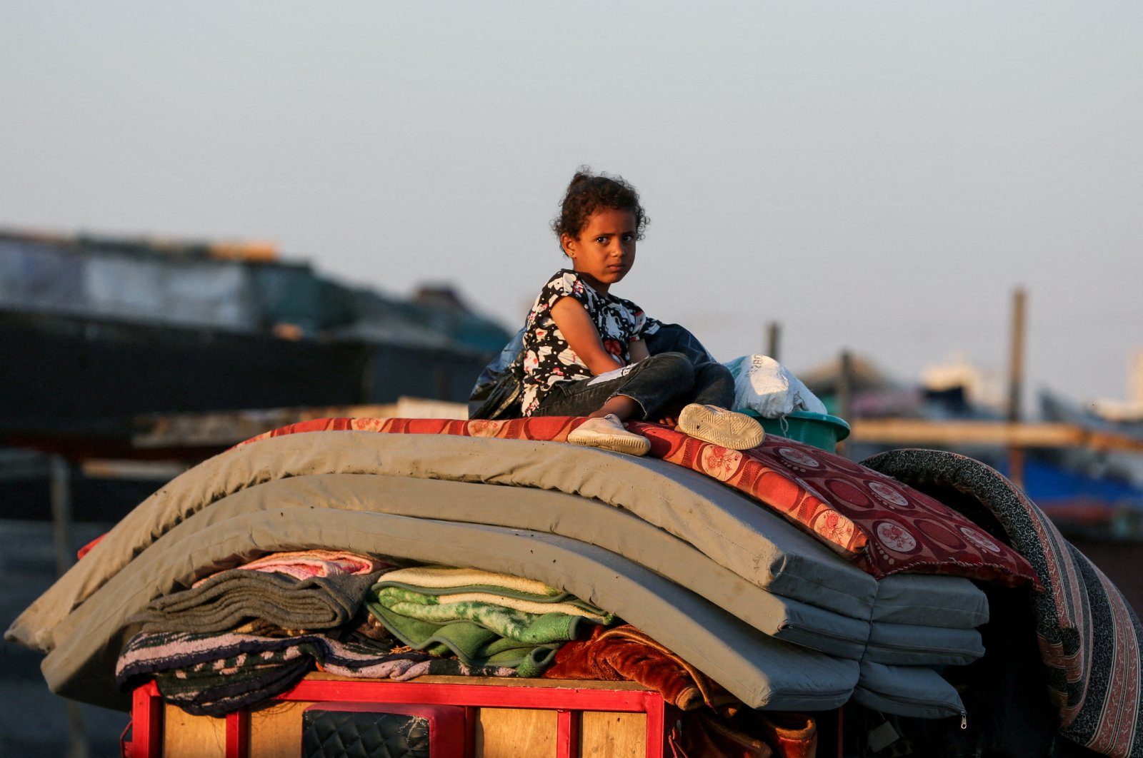 A Palestinian child sits on top of belongings as they flee Rafah due to an Israeli military operation, in Rafah, southern Gaza Strip, Palestine, June 7, 2024. (Reuters Photo)