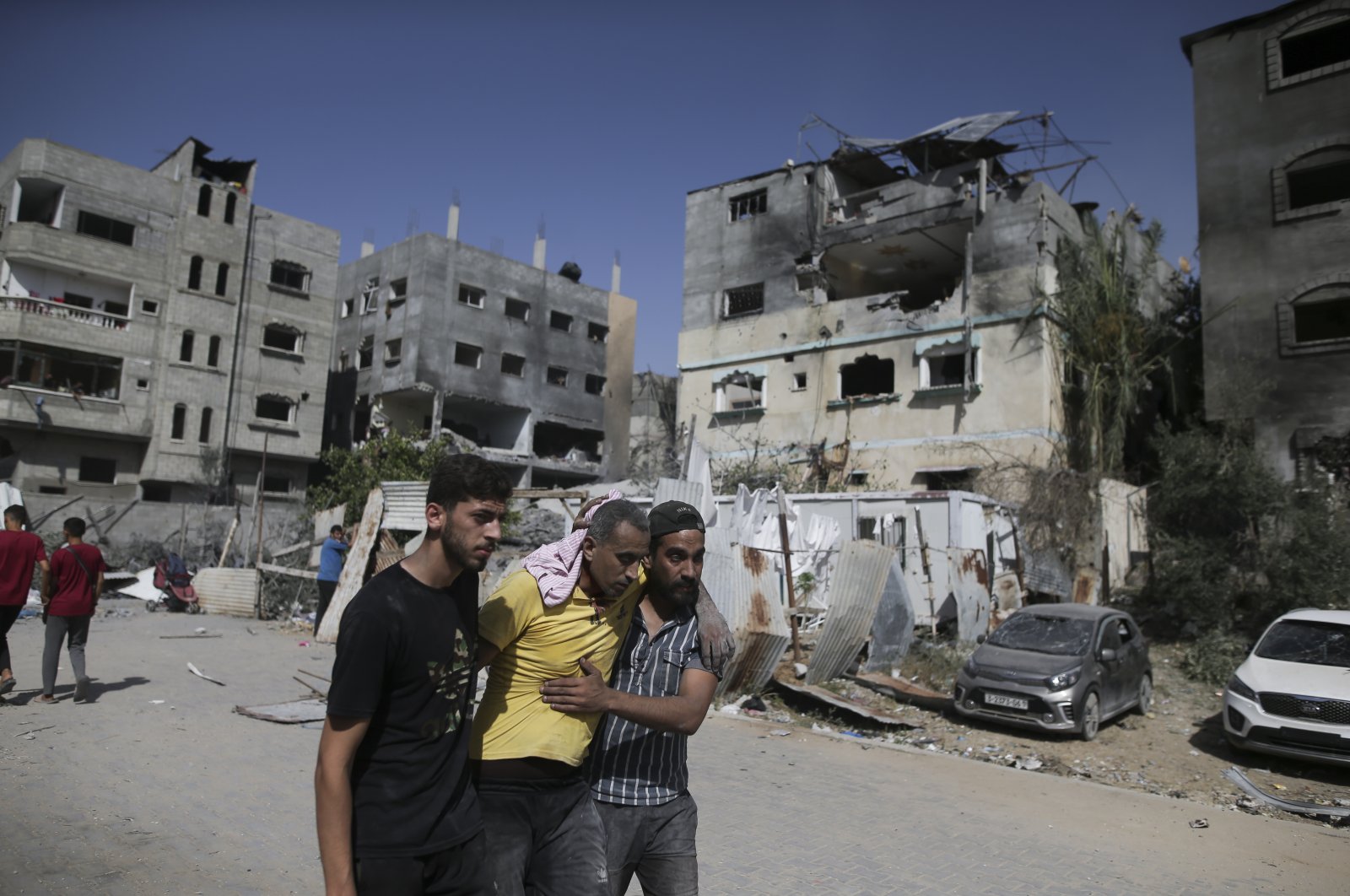 Palestinians help a wounded man after Israeli strikes in Nuseirat refugee camp, Gaza Strip, Palestine, June 8, 2024. (AP Photo)