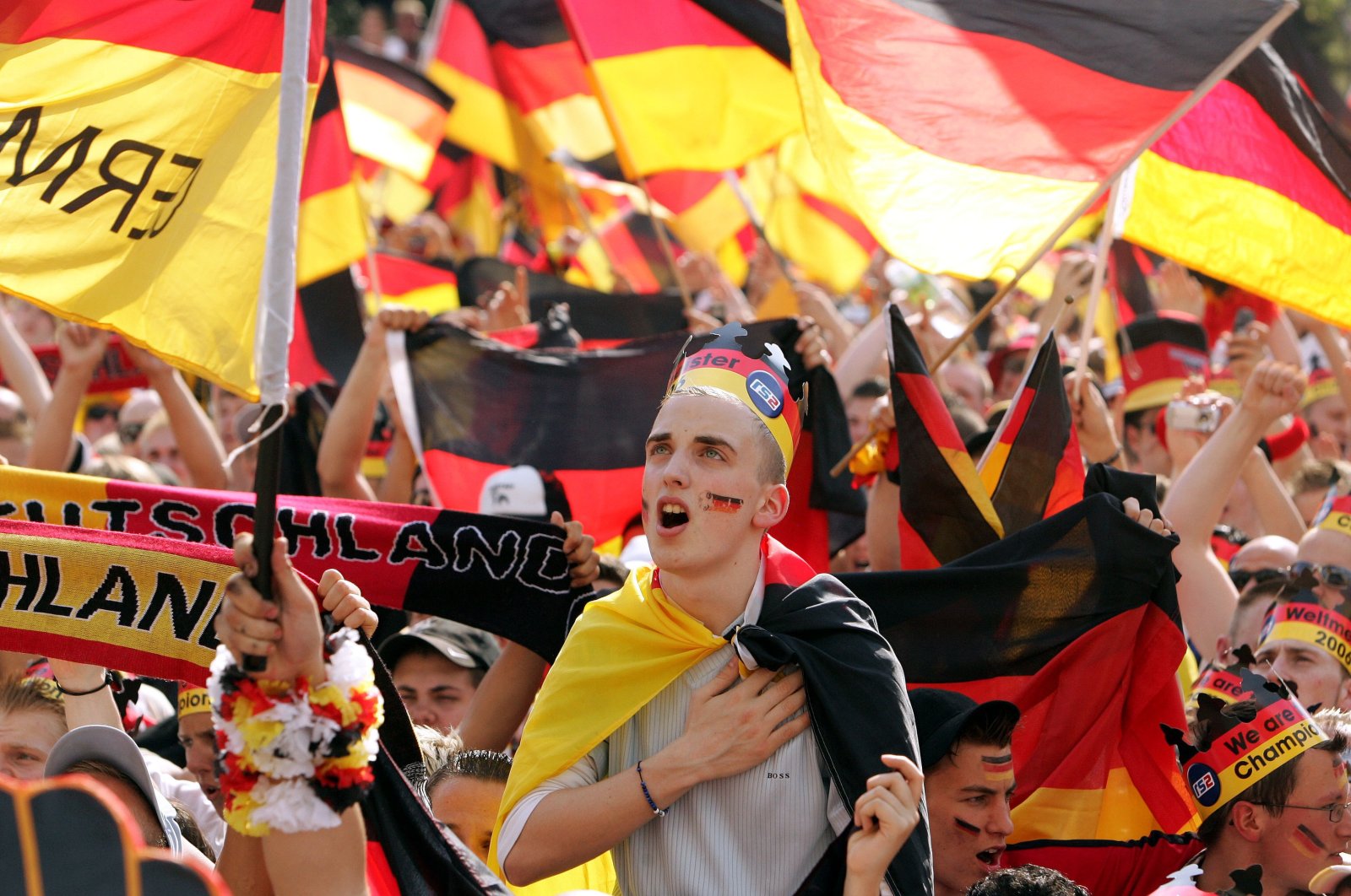 A German fan sings the German national anthem prior to the beginning of the Round of 16 of the World Cup match against Sweden at the public viewing area, Berlin, Germany, June 24, 2006. (AP Photo)