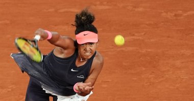 Japan's Naomi Osaka serves to Poland's Iga Swiatek during their women's singles match on Court Philippe-Chatrier on Day 4 of the French Open at the Roland Garros, Paris, France, May 29, 2024. (AFP Photo)