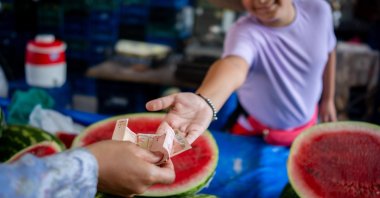 A boy sells fruits in a bazaar, March 3, 2023. (Getty Images Photo)