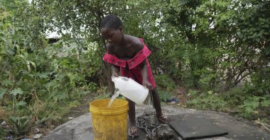 A young girl fetches water from a well in Lilanda township, Lusaka, Zambia, March 9, 2024. (AP Photo)