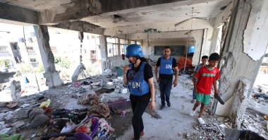 Members of a United Nations investigation team visit a school run by the UN Relief and Works Agency for Palestine Refugees (UNRWA) which was hit during an Israeli army strike the day before, in the Nuseirat camp in the central Gaza Strip, June 7, 2024. (AFP Photo)