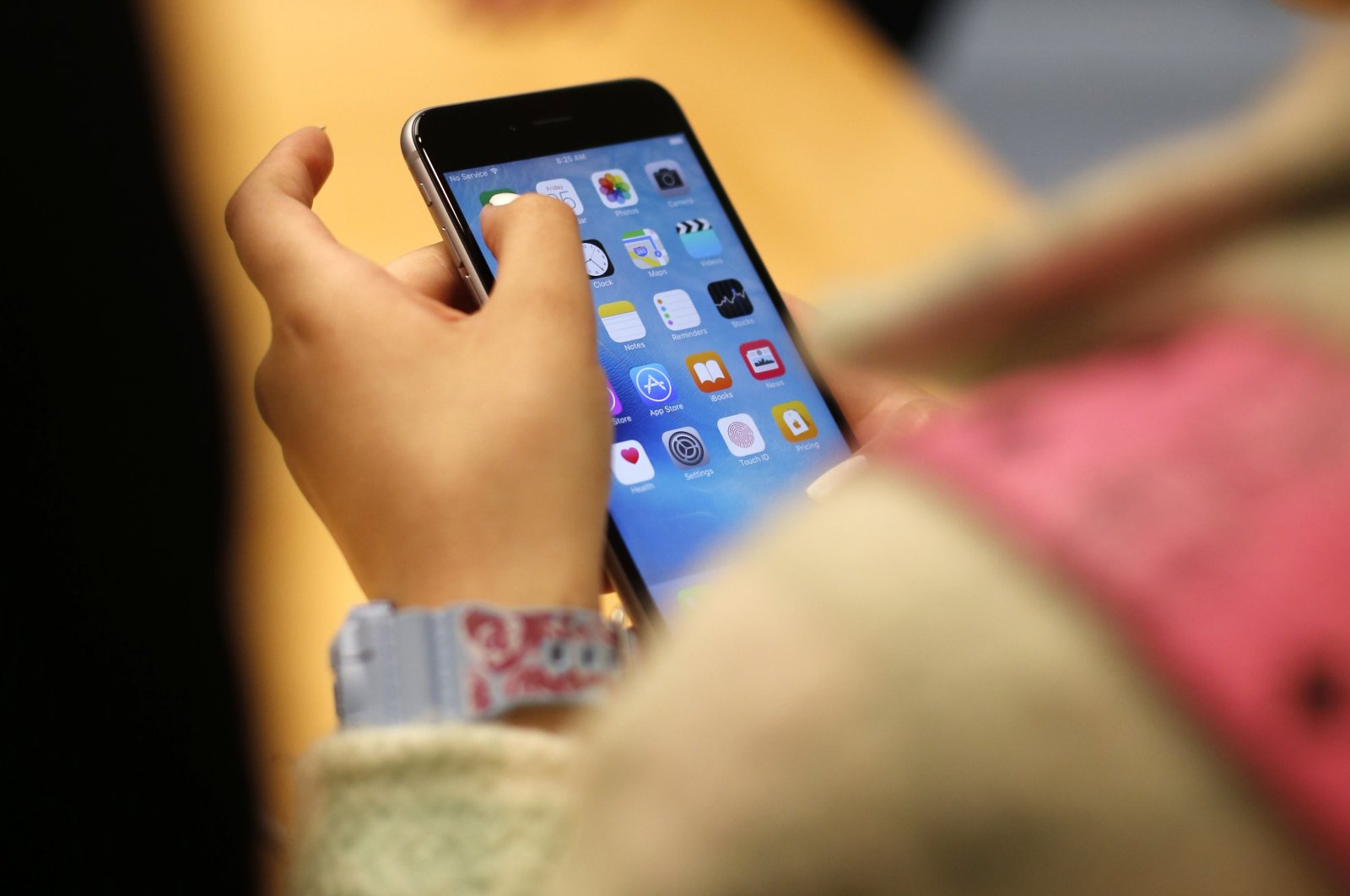 A child holds an iPhone at an Apple store in Chicago, U.S., Sept. 25, 2015. (AP Photo)