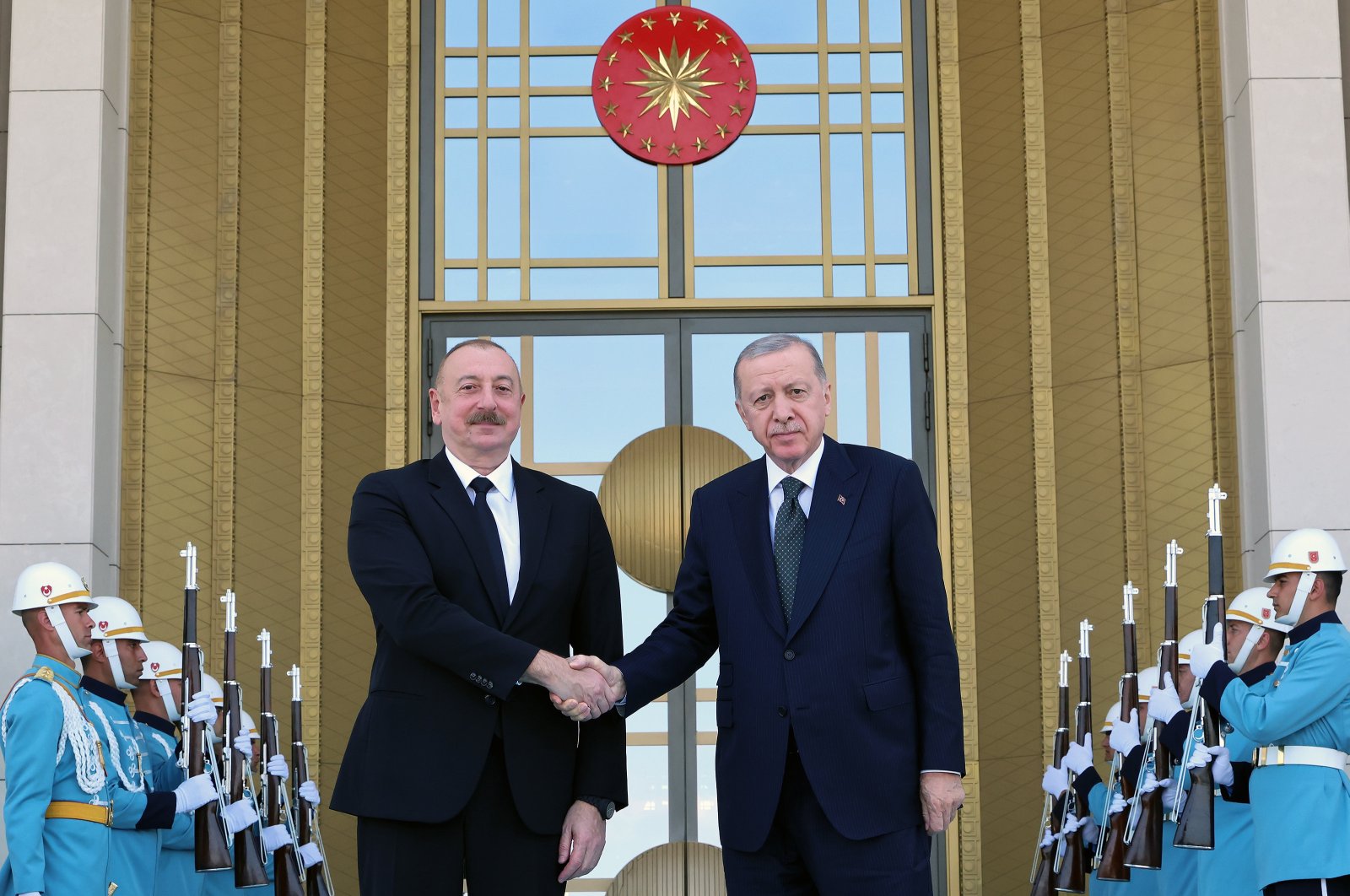 President Recep Tayyip Erdoğan (R) shakes hands with Azerbaijani President Ilham Aliyev outside the Presidential Complex, Ankara, Türkiye, June 10, 2024. (AA Photo)