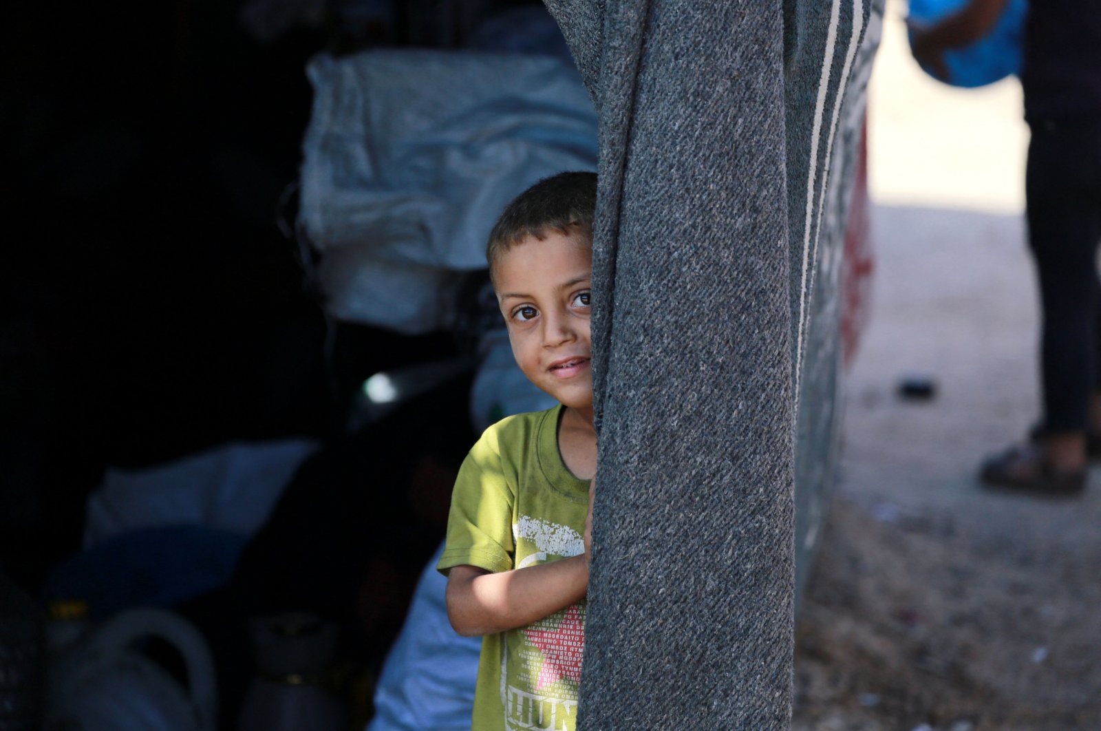 A Palestinian boy peeps from inside a tent at a camp for displaced people in Deir al-Balah, in the central Gaza Strip, Palestine, June 11, 2024. (AFP Photo)