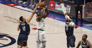Boston Celtics guard Jaylen Brown shoots between Dallas Mavericks guard Dante Exum (L) and center Daniel Gafford defend during the first half of the NBA Finals game three, Arlington, Texas, U.S., June 12, 2024. (EPA Photo)