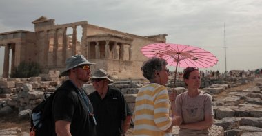 Tourists visit the Parthenon temple atop the Acropolis Hill archaeological site before it closes due to a heatwave hitting Athens, Greece, June 13, 2024. (Reuters Photo)