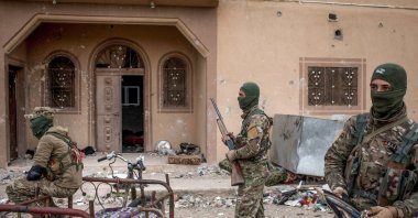 YPG/PKK terrorists are seen in front of a building in Baghouz, Syria, March 24, 2019. (Getty Images, File Photo)
