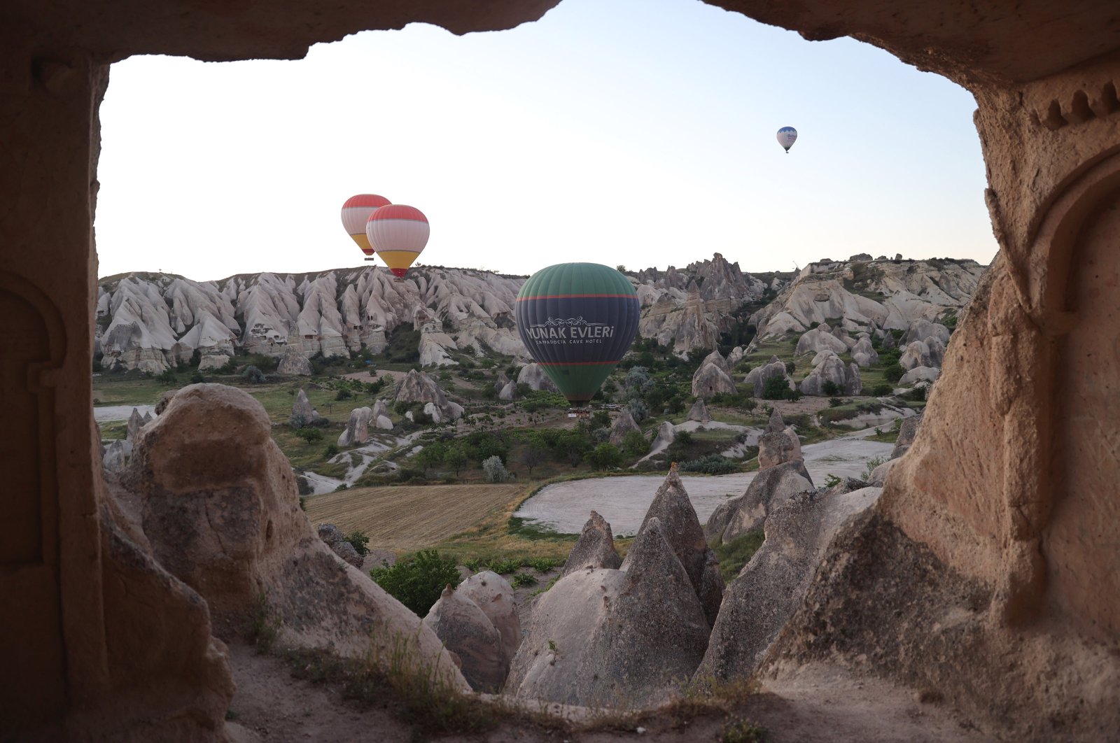 In Cappadocia, hot air balloons created a beautiful sight in the green-toned valleys, Cappadocia, Türkiye, June 4, 2024. (AA Photo) 