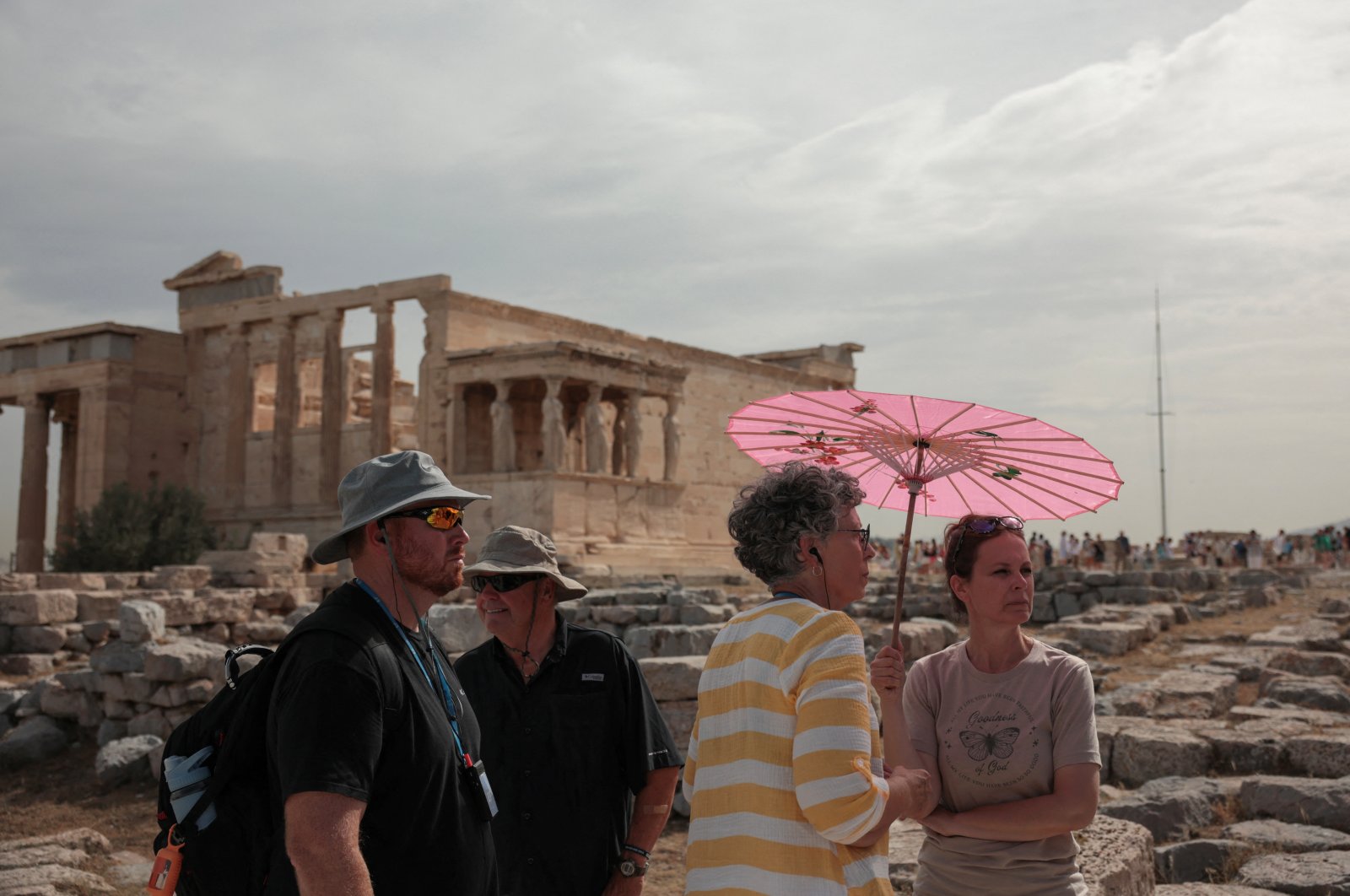 Tourists visit the Parthenon temple atop the Acropolis Hill archaeological site before it closes due to a heatwave hitting Athens, Greece, June 13, 2024. (Reuters Photo)