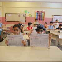 Students pose with their report card following the end of the school year, Mardin, southeastern Türkiye, June 14, 2024. (AA Photo)