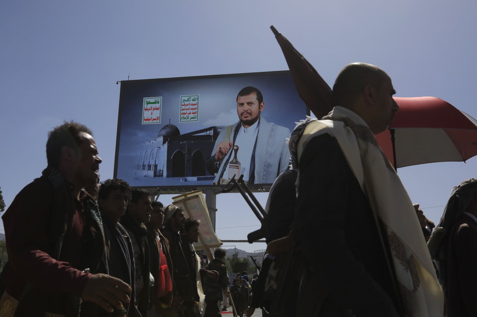 Houthi supporters pass a billboard featuring Houthis&#039; leader Abdul-Malik al-Houthi, during a protest against the U.S. and Israel, and in solidarity with the Palestinian people, Sanaa, Yemen, June 7, 2024. (EPA Photo)